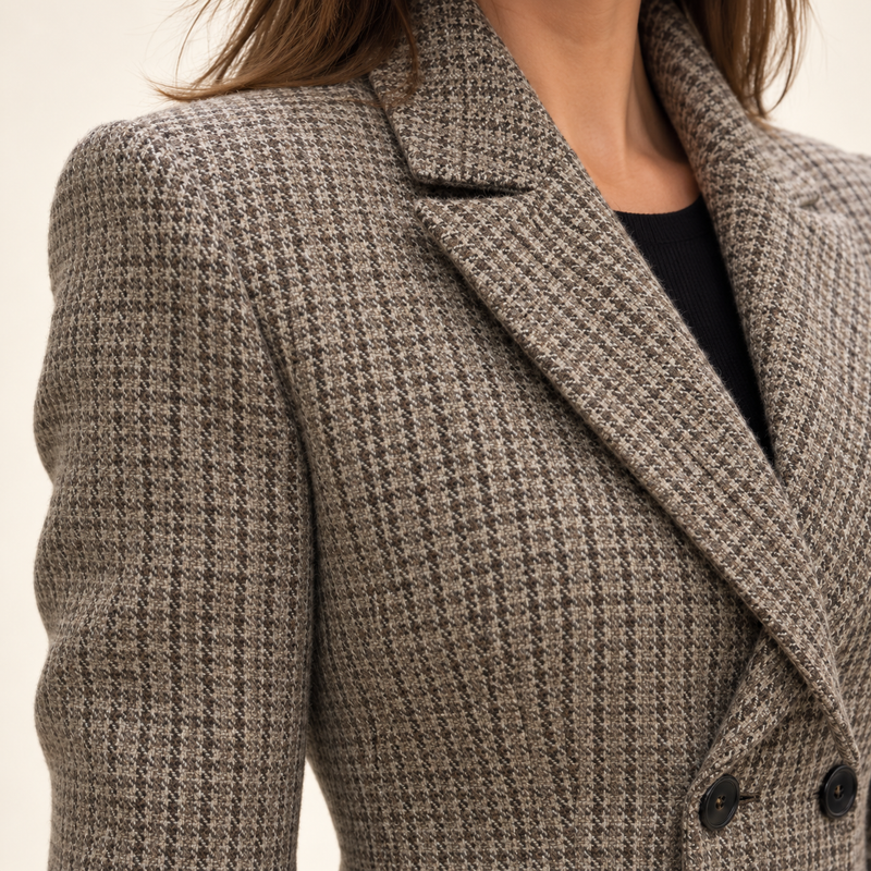 Close-up of the Nadia Alexander Amelia blazer showing the brown houndstooth Harris Tweed fabric, tailored lapels and shoulder detail.
