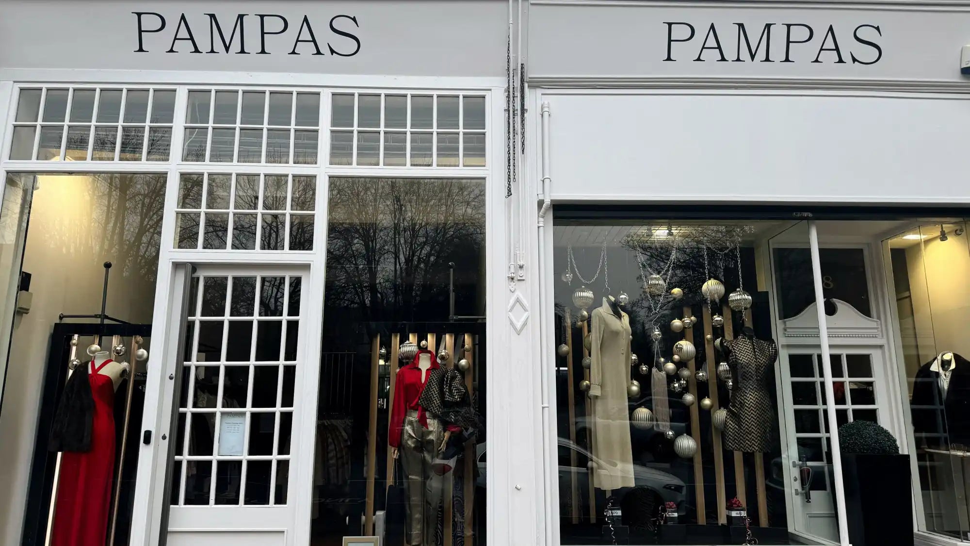 White and black dress with silver accents, modern design.
