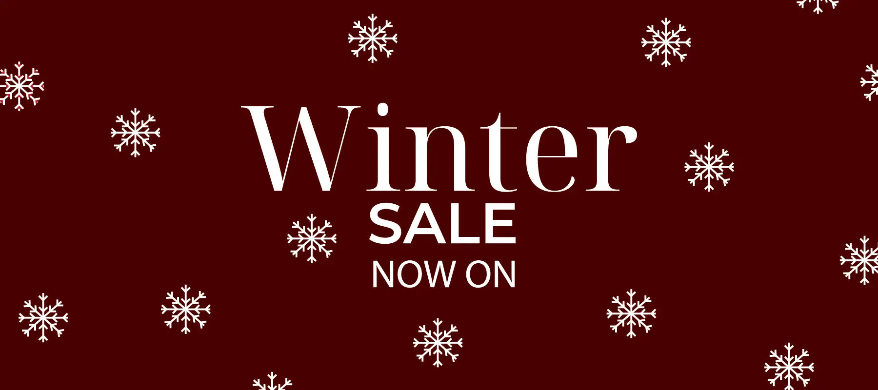 White ’winter sale now on’ text with snowflake patterns on a deep red background.